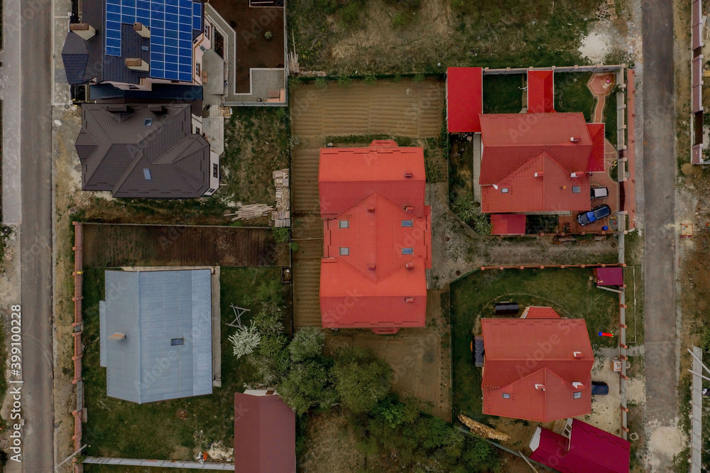 Aerial top view of a private house with paved yard with green grass lawn with concrete foundation floor Aerial top view of a private house with paved yard with green grass lawn with concrete foundation floor