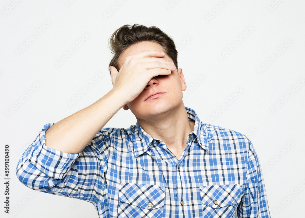Handsome man closing his eyes over white background Handsome man closing his eyes over white background