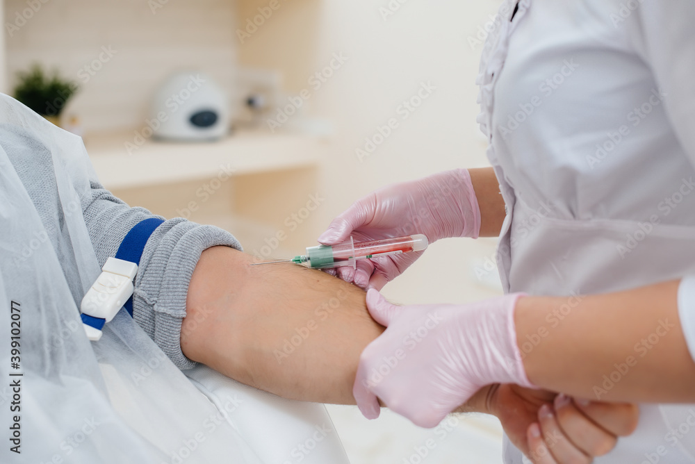 Close-up take blood from a person's vein for analysis and testing for viruses. Formation of the immune system and antibodies. Close-up take blood from a person's vein for analysis and testing for viruses. Formation of the immune system and antibodies.