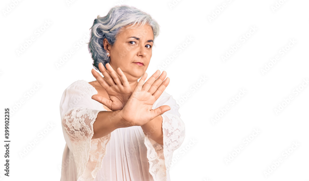 Senior woman with gray hair wearing bohemian style rejection expression crossing arms doing negative sign, angry face Senior woman with gray hair wearing bohemian style rejection expression crossing arms doing negative sign, angry face