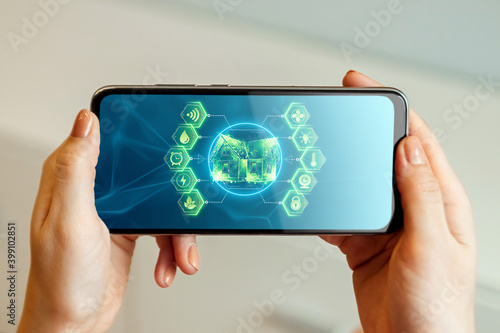 Smart home interface in a smartphone in a man's hand. Double exposure. Automation concept, modern house, new technologies.