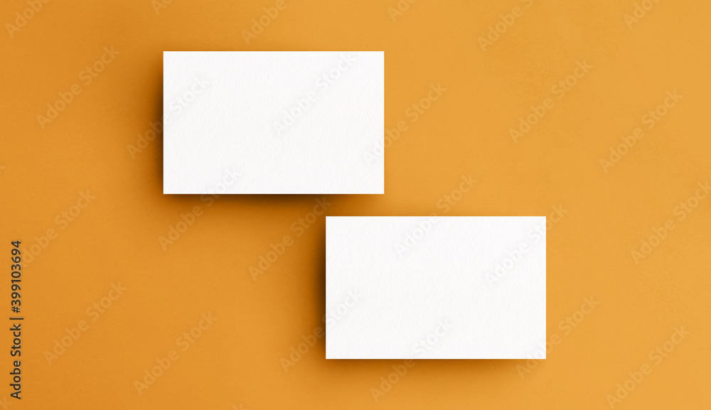 Two business card mockup on a yellow surface background. Branding design concept. Insert your design Two business card mockup on a yellow surface background. Branding design concept. Insert your design