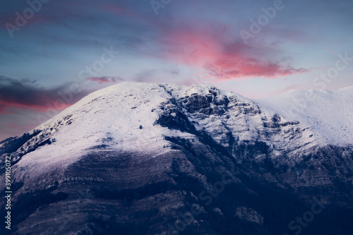 Stunning view of a snow capped mountain range during a dramatic sunset. Campocatino, Frosinone, Italy. © Travel Wild