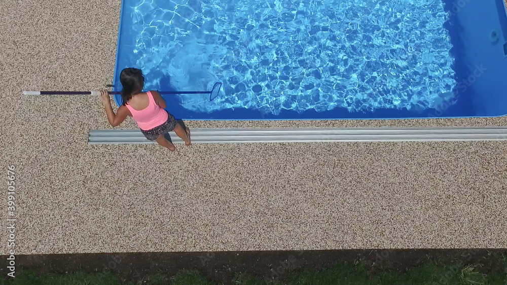 Cleaning the home pool.