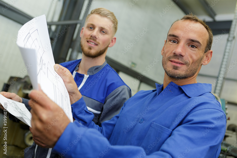 workers in overalls studying the blueprint workers in overalls studying the blueprint