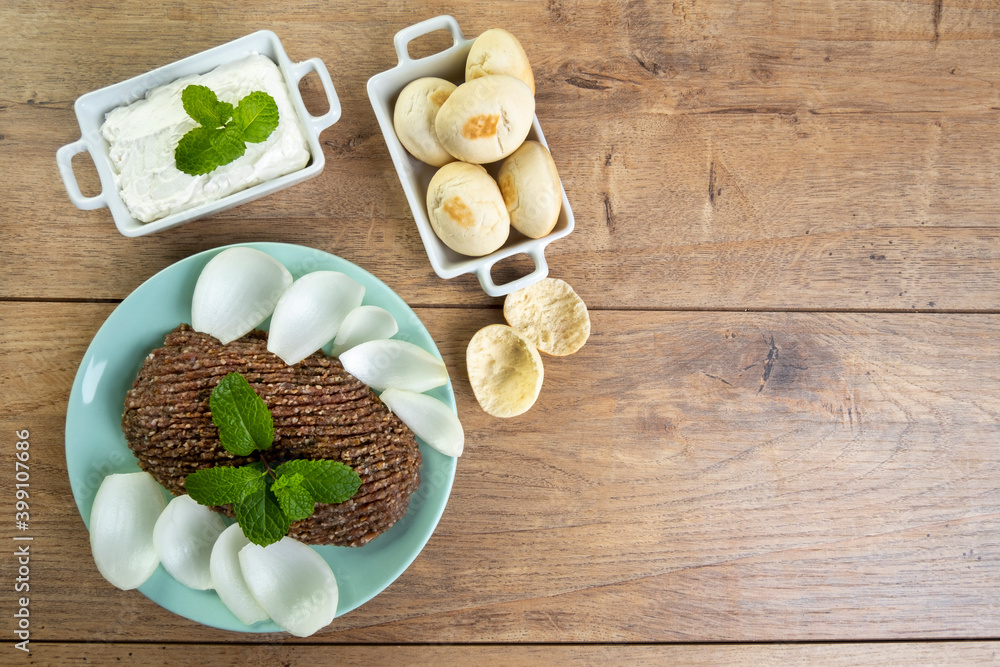 raw quibe with sliced onion, dried curd, pita bread and mint leaves raw quibe with sliced onion, dried curd, pita bread and mint leaves