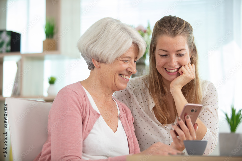 mother with daughter sitting on sofa using social media mother with daughter sitting on sofa using social media