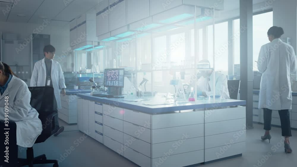 Medical Science Laboratory with Diverse Multi-Ethnic Team of Biochemistry Scientists Developing Drugs, Medicine, Doing Biotechnology Research. Working on Computer, Using Microscope, Analysing Samples Medical Science Laboratory with Diverse Multi-Ethnic Team of Biochemistry Scientists Developing Drugs, Medicine, Doing Biotechnology Research. Working on Computer, Using Microscope, Analysing Samples