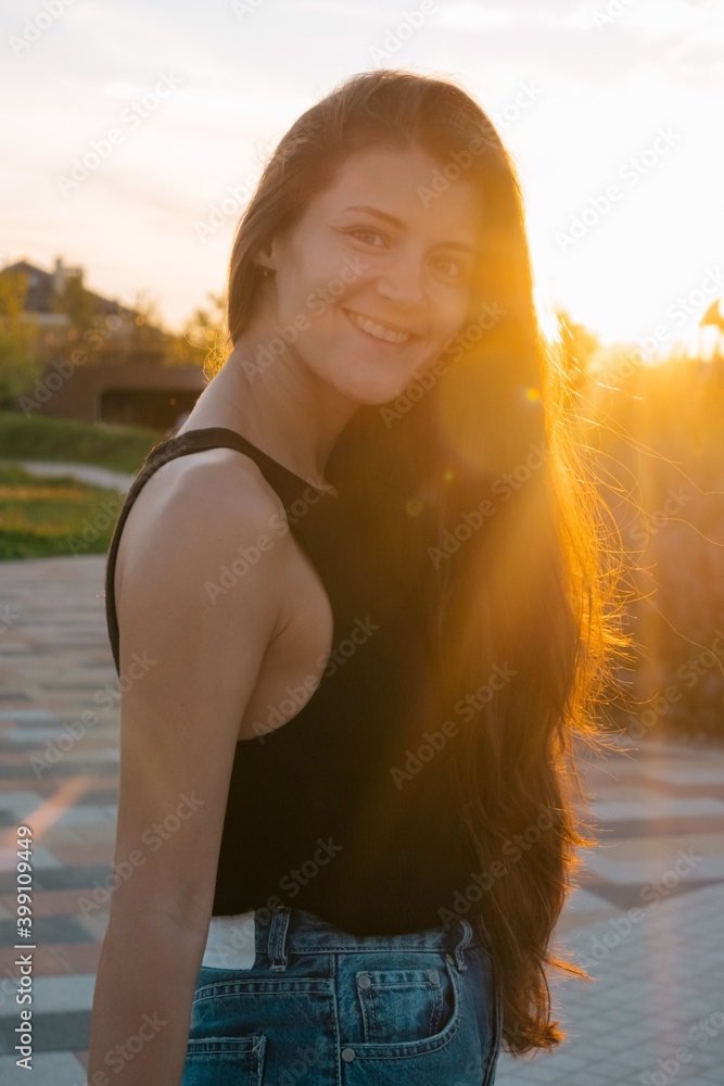 pretty young woman with healthy skin and long hair portrait at the sunset in summer