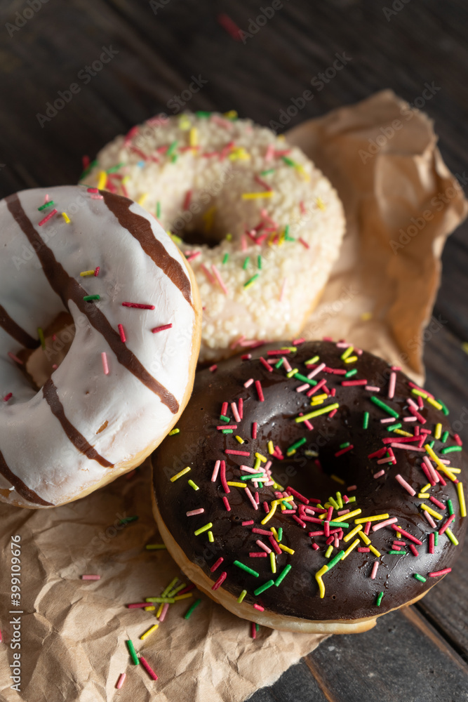 Various fresh-baked donuts on a wooden background Various fresh-baked donuts on a wooden background