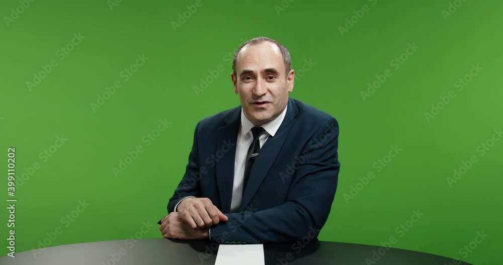 Positive male newsanchor reporting on current events. Happy man expressively gesturing and looking into camera, shot on green chroma key background 4k footage Positive male newsanchor reporting on current events. Happy man expressively gesturing and looking into camera, shot on green chroma key background 4k footage