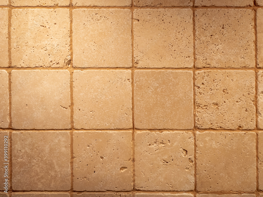 Fototapeta premium Old square stone tiles with brown holes. Retro texture background.