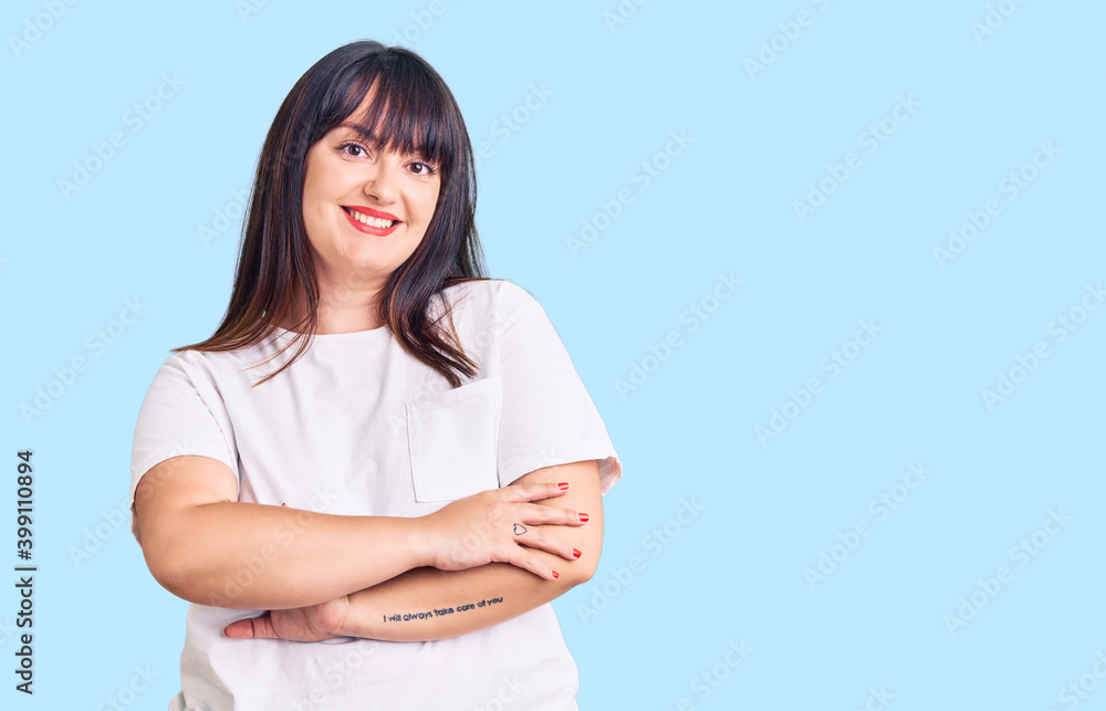 Young plus size woman wearing casual clothes happy face smiling with crossed arms looking at the camera. positive person. Young plus size woman wearing casual clothes happy face smiling with crossed arms looking at the camera. positive person.