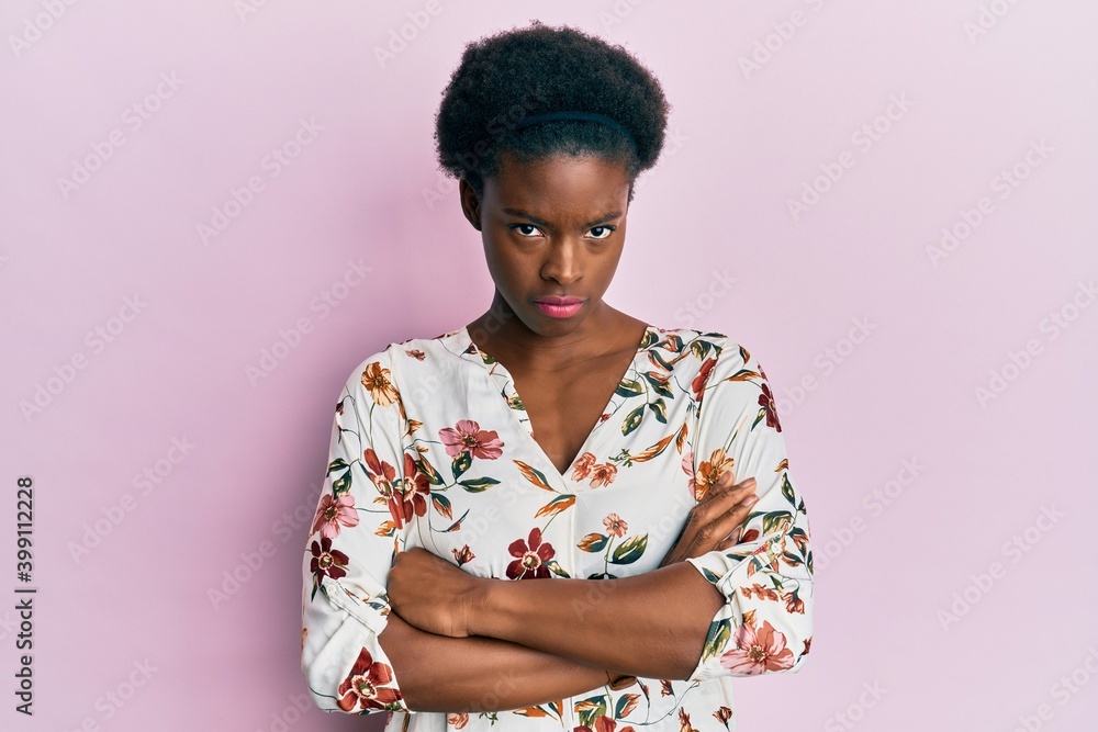 Young african american girl wearing casual clothes skeptic and nervous, disapproving expression on face with crossed arms. negative person. Young african american girl wearing casual clothes skeptic and nervous, disapproving expression on face with crossed arms. negative person.