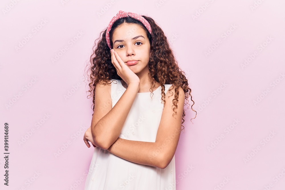 Beautiful kid girl with curly hair wearing casual clothes thinking looking tired and bored with depression problems with crossed arms. Beautiful kid girl with curly hair wearing casual clothes thinking looking tired and bored with depression problems with crossed arms.