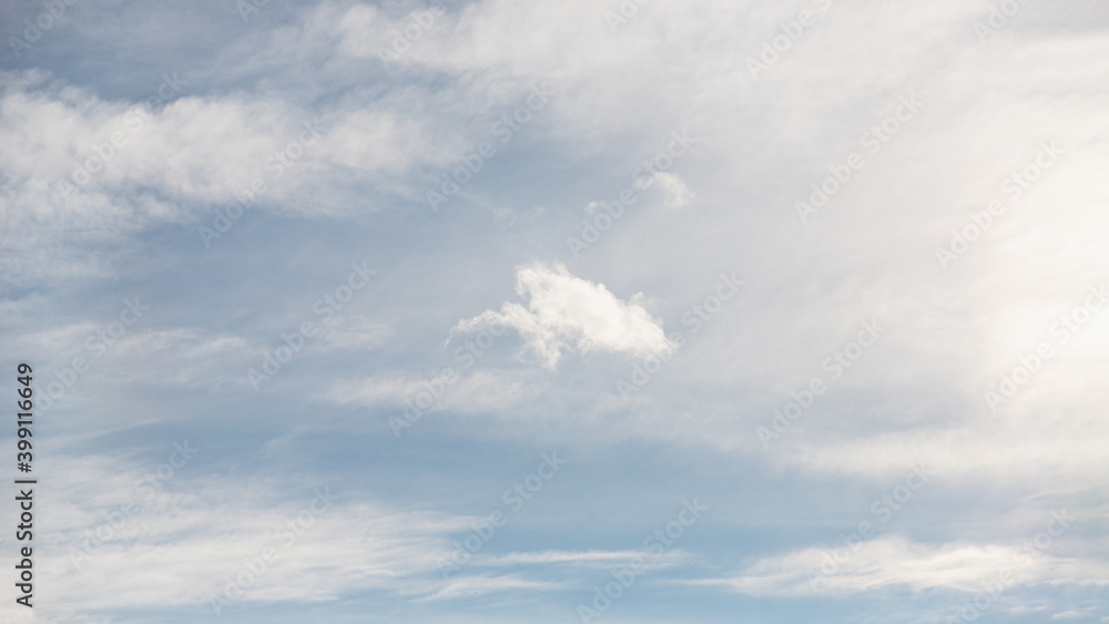 Cirrocumulus clouds in the pale blue sky background
