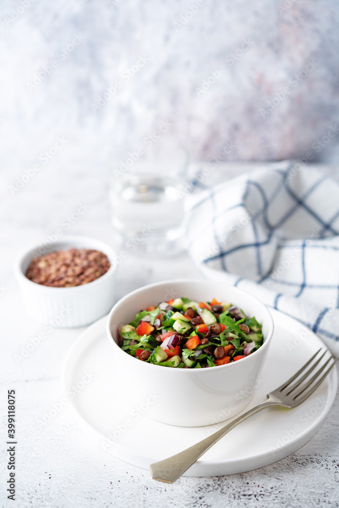 Green lentil red bell pepper cucumber parsley salad in a bowl Green lentil red bell pepper cucumber parsley salad in a bowl