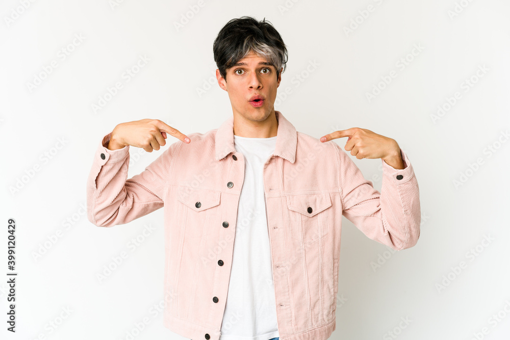 Young skinny hispanic man points down with fingers, positive feeling. Young skinny hispanic man points down with fingers, positive feeling.