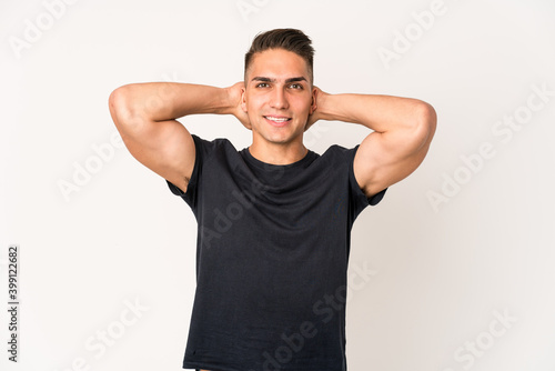 Young caucasian handsome man isolated stretching arms, relaxed position.