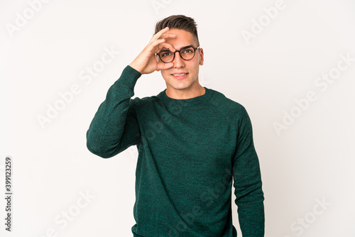 Young caucasian handsome man isolated excited keeping ok gesture on eye. © Asier