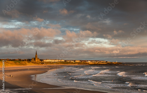 First light on Tynemouth's Longsands beach, with surfers and dog-walkers enjoying a lovely start to the day photo