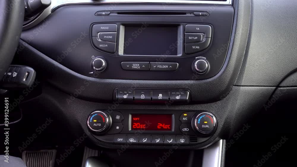 man presses the air conditioner button in the car man presses the air conditioner button in the car