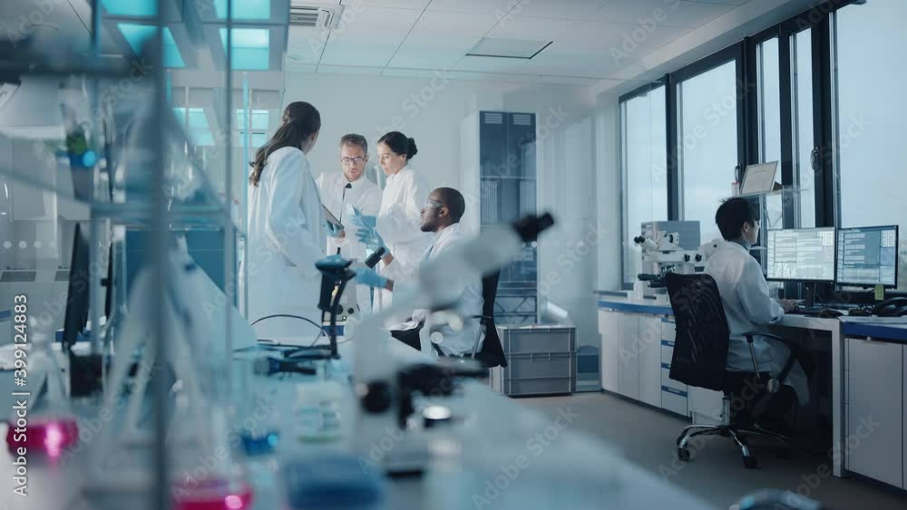 Medical Science Laboratory with Diverse Multi-Ethnic Team of Microbiology Scientists Have Meeting on Developing Drugs, Medicine, Doing Biotechnology Research. Working on Computers, Analyzing Samples Medical Science Laboratory with Diverse Multi-Ethnic Team of Microbiology Scientists Have Meeting on Developing Drugs, Medicine, Doing Biotechnology Research. Working on Computers, Analyzing Samples