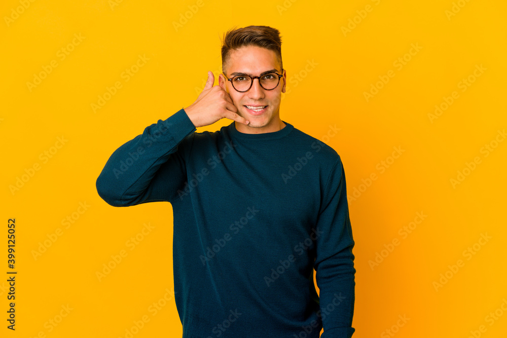 Young handsome caucasian man isolated showing a mobile phone call gesture with fingers. Young handsome caucasian man isolated showing a mobile phone call gesture with fingers.