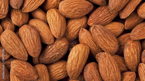 Background and texture of rotating almond nuts. View from above.	