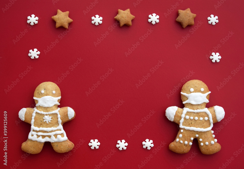 Festive frame created from gingerbread couple with protective face masks and decoration. Creative concept in coronavirus (COVID-19) time. Christmas or New year greeting card, copy space for text