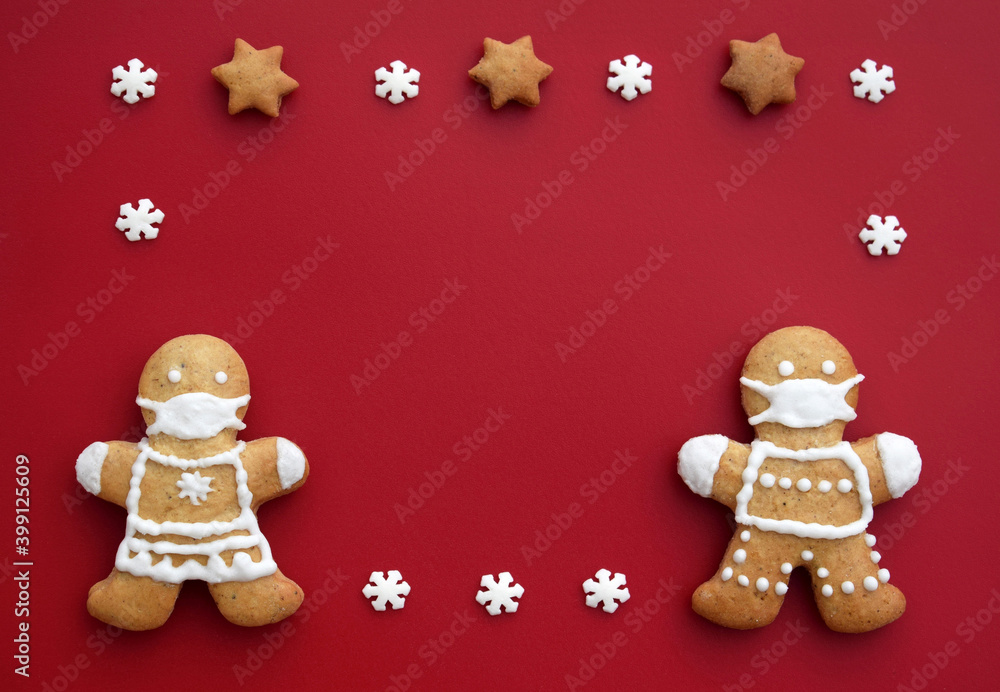 Festive frame created from gingerbread couple with protective face masks and decoration. Creative concept in coronavirus (COVID-19) time. Christmas or New year greeting card, copy space for text Festive frame created from gingerbread couple with protective face masks and decoration. Creative concept in coronavirus (COVID-19) time. Christmas or New year greeting card, copy space for text