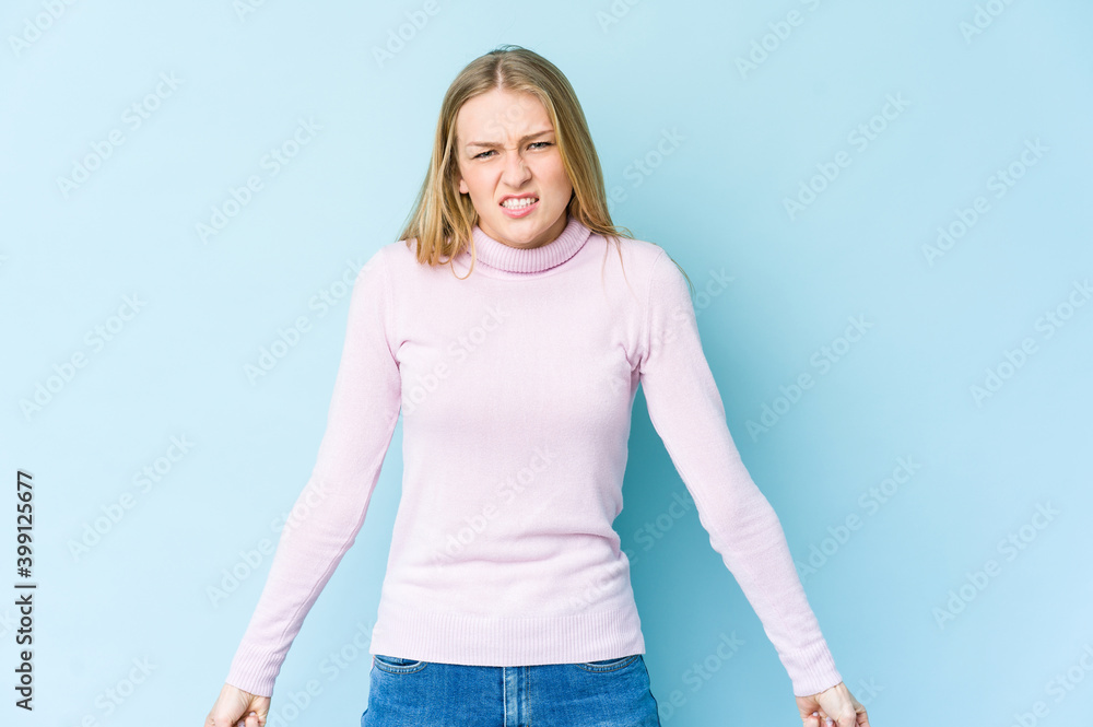 Young blonde woman isolated on blue background shouting very angry, rage concept, frustrated. Young blonde woman isolated on blue background shouting very angry, rage concept, frustrated.