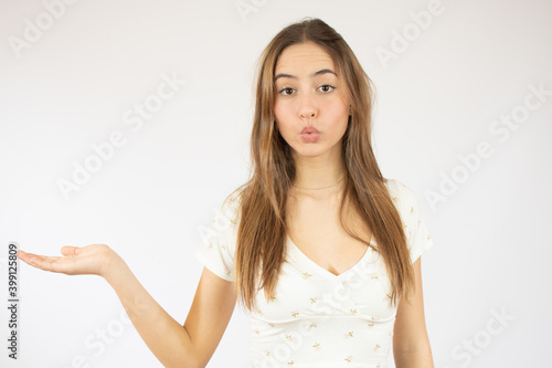 Wallpaper Mural Beautiful caucasian young woman showing product isolate over white background Torontodigital.ca