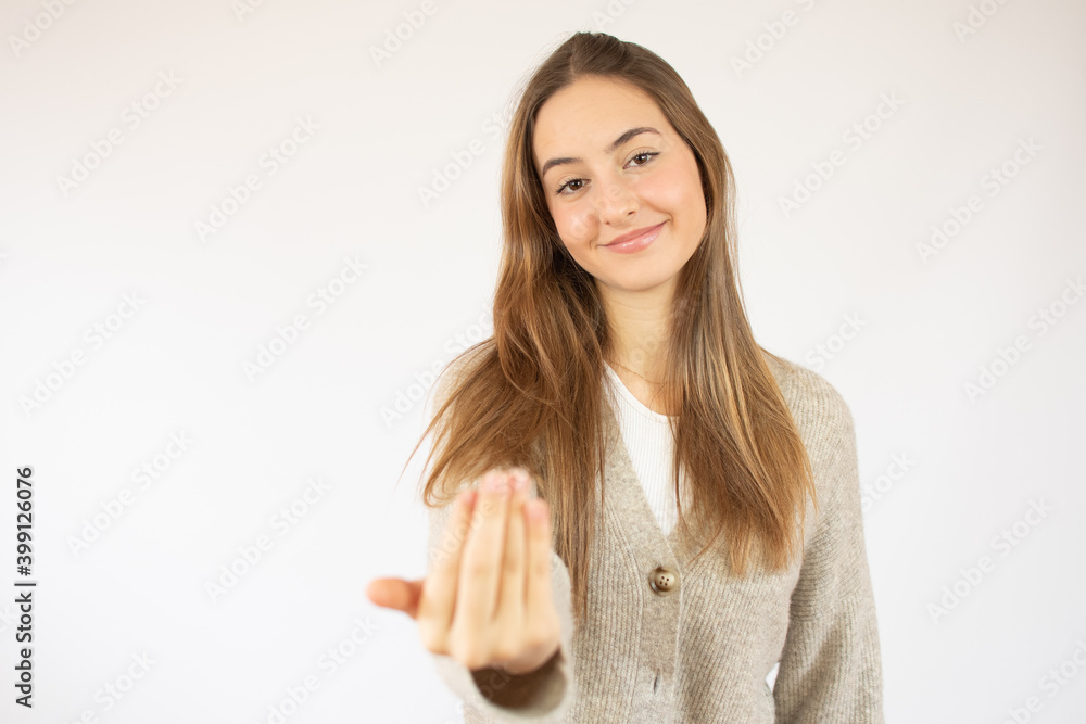 Young woman over isolated white background inviting to come with hand. Happy that you came Young woman over isolated white background inviting to come with hand. Happy that you came