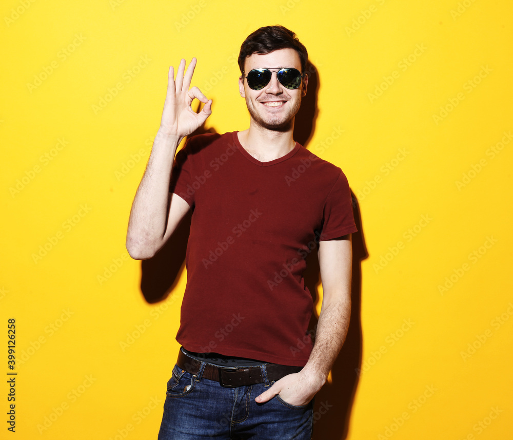 lifestyle and people concept: Happy handsome man wearing casual showing ok lifestyle and people concept: Happy handsome man wearing casual showing ok