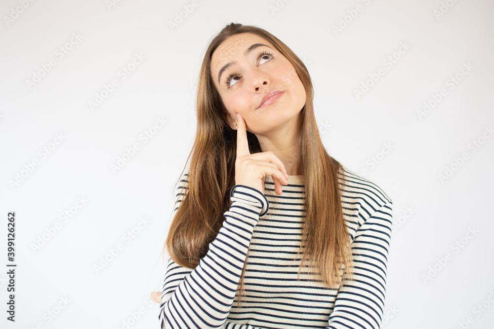 Image of thinking young woman standing isolated over white background. Looking aside. Image of thinking young woman standing isolated over white background. Looking aside.