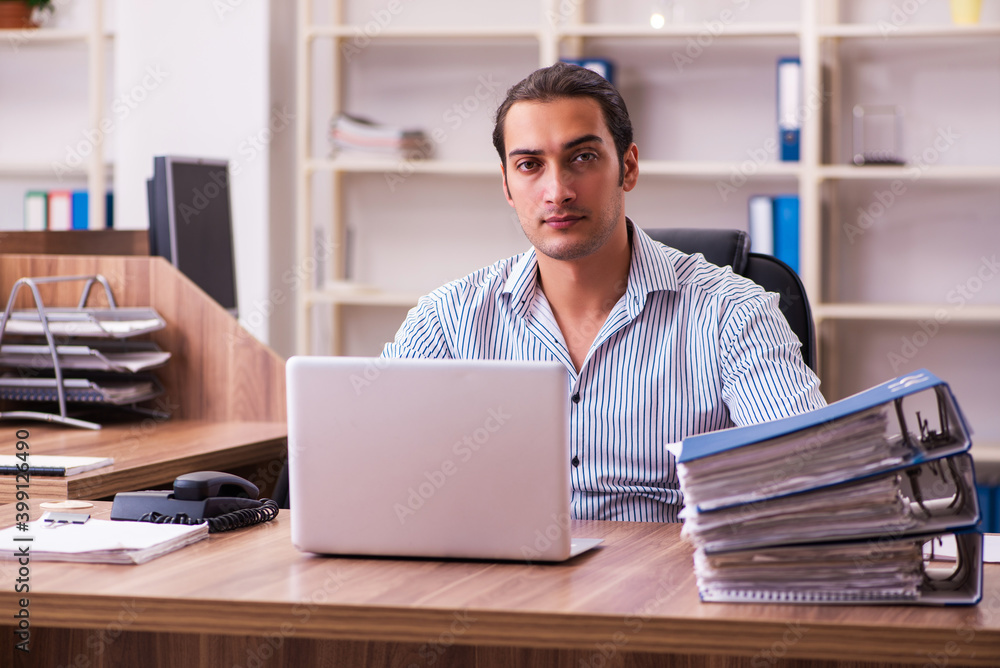 Young male employee working in the office Young male employee working in the office