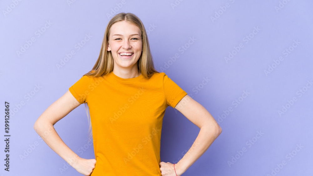 Young blonde woman isolated on purple background confident keeping hands on hips. Young blonde woman isolated on purple background confident keeping hands on hips.