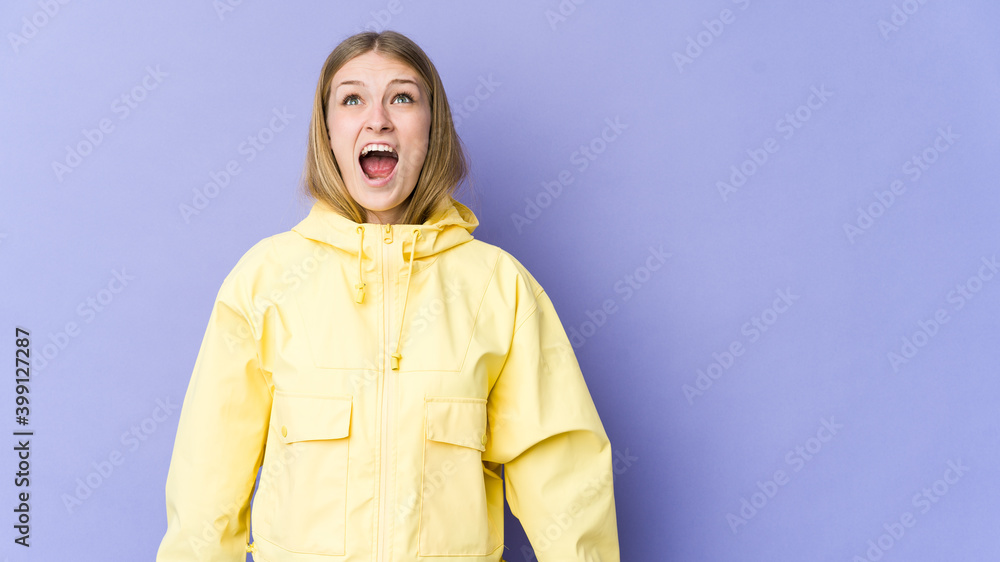 Young blonde woman isolated on purple background shouting very angry, rage concept, frustrated. Young blonde woman isolated on purple background shouting very angry, rage concept, frustrated.
