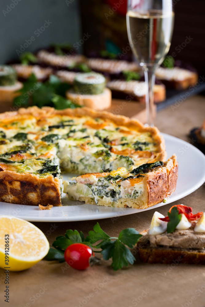 Shrimp, salmon , broccoli and spinach pie for Christmas celebration with bokeh lights. Delicious home made tart for family dinner or New year party Shrimp, salmon , broccoli and spinach pie for Christmas celebration with bokeh lights. Delicious home made tart for family dinner or New year party