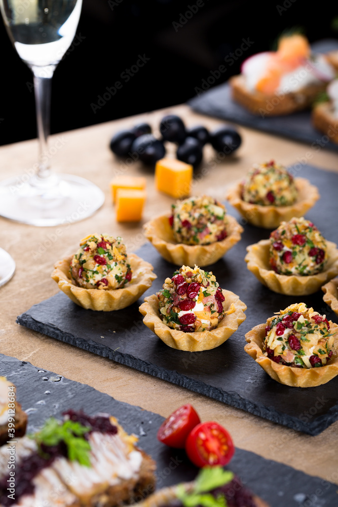 Christmas tapas with cheese balls and white wine, New year celebration, toasts for party dinner Christmas tapas with cheese balls and white wine, New year celebration, toasts for party dinner