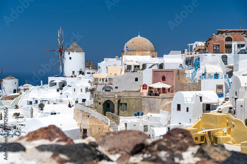 Architecture and landscape of the Santorini island., famous luxury travel vacation getaway. Oia white village with Blue Domes and mills. Amazing warm sunny day