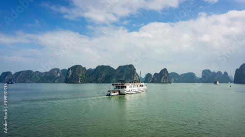 Ha Long Bay, Vietnam - December 2015: Tourist boat sailing in Ha Long Bay at the Gulf of Tonkin of the South China Sea. The Halong Bay is a popular tourist destination of Asia
