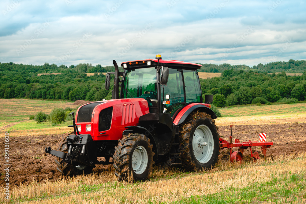 Farmer in tractor preparing land for sowing, plowing the field Farmer in tractor preparing land for sowing, plowing the field