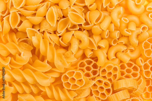 Different pasta types in a heap on the table. Top view