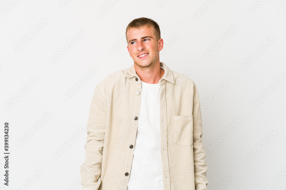 Fototapeta premium Young caucasian handsome man laughs and closes eyes, feels relaxed and happy.