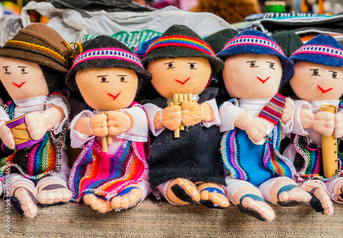 Row of male rag dolls in traditional clothes playing musical instruments, Otavalo Market, Ecuador
 photo