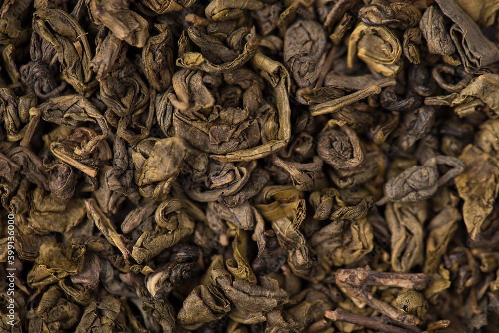 Closeup macro photo of dry loose green herbal tea leaves textured background Closeup macro photo of dry loose green herbal tea leaves textured background