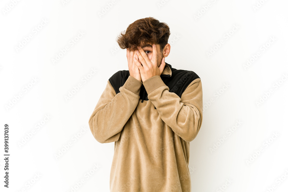 Young arab man on white background blink through fingers frightened and nervous. Young arab man on white background blink through fingers frightened and nervous.