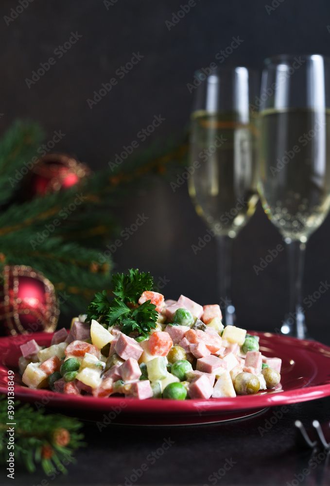 Traditional New Year's salad Olivier. New Year's festive table and glasses of champagne. Traditional New Year's salad Olivier. New Year's festive table and glasses of champagne.